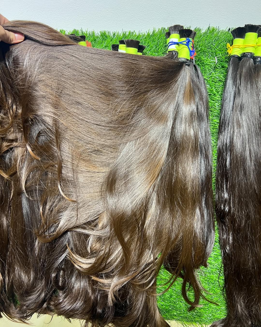Woman wearing natural dark brown human hair extensions, silky and straight – Black Diamond Collection.