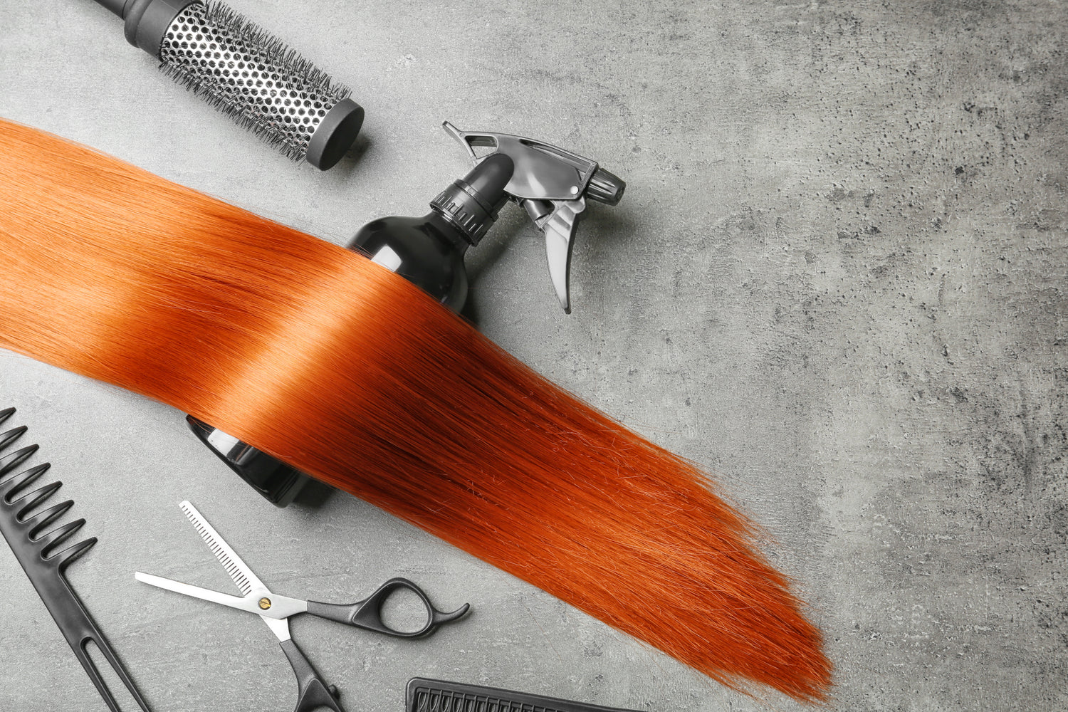 Close-up of copper hair extensions on a model, showing long, wavy texture