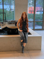 Woman wearing a long copper brown human hair wig