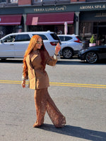 Woman wearing a long copper brown human hair wig