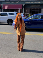 Woman wearing a long copper brown human hair wig